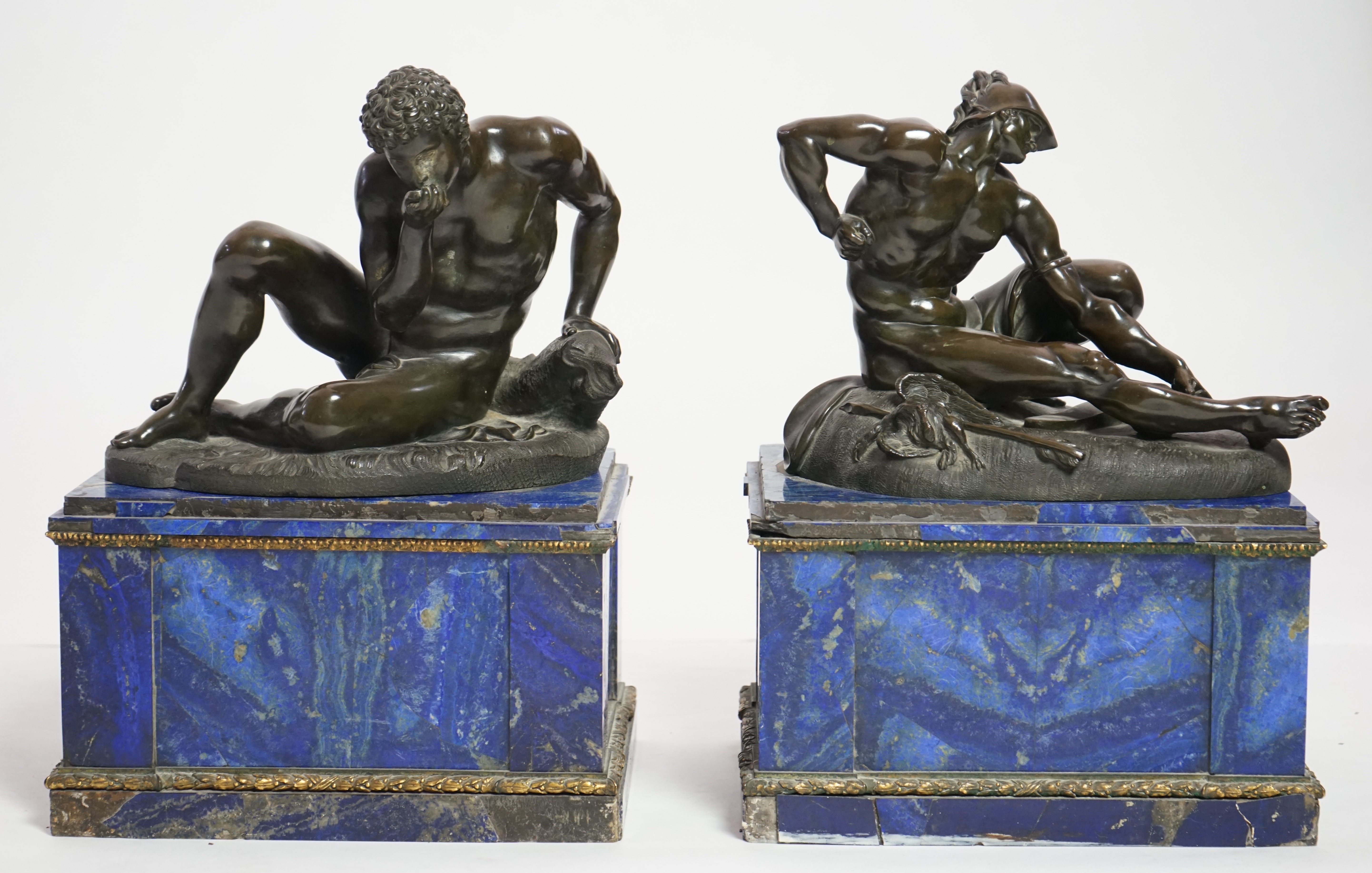 After the antique, a pair of late 18th/early 19th century Grand Tour souvenir bronze figures of seated warriors